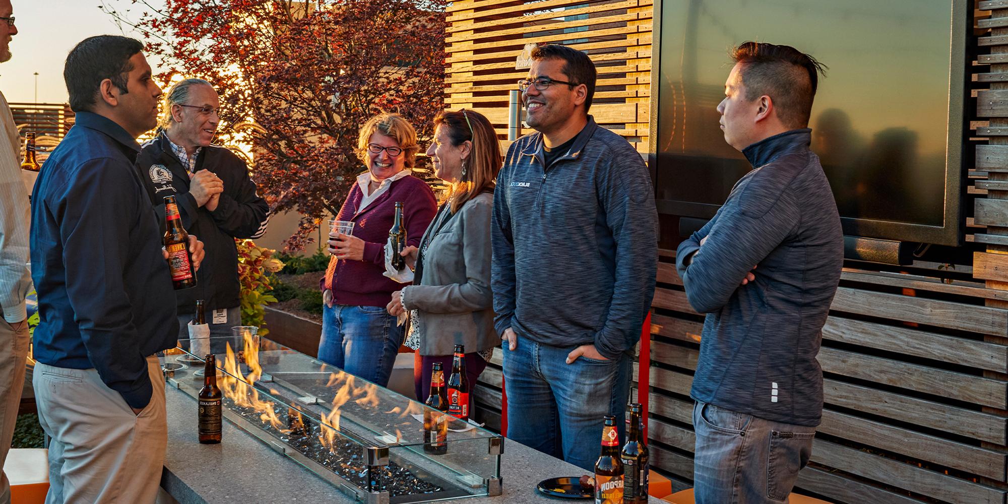 Staff enjoying the outdoor open space and rooftop terrace at The District corporate office park, Burlington